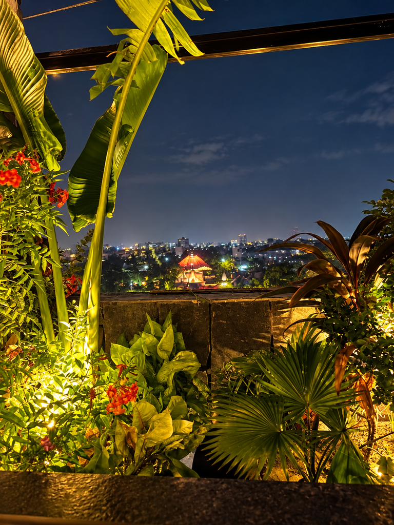 Rooftop restaurants in Panchkula with a beautiful nighttime city view surrounded by lush greenery at Upstairs