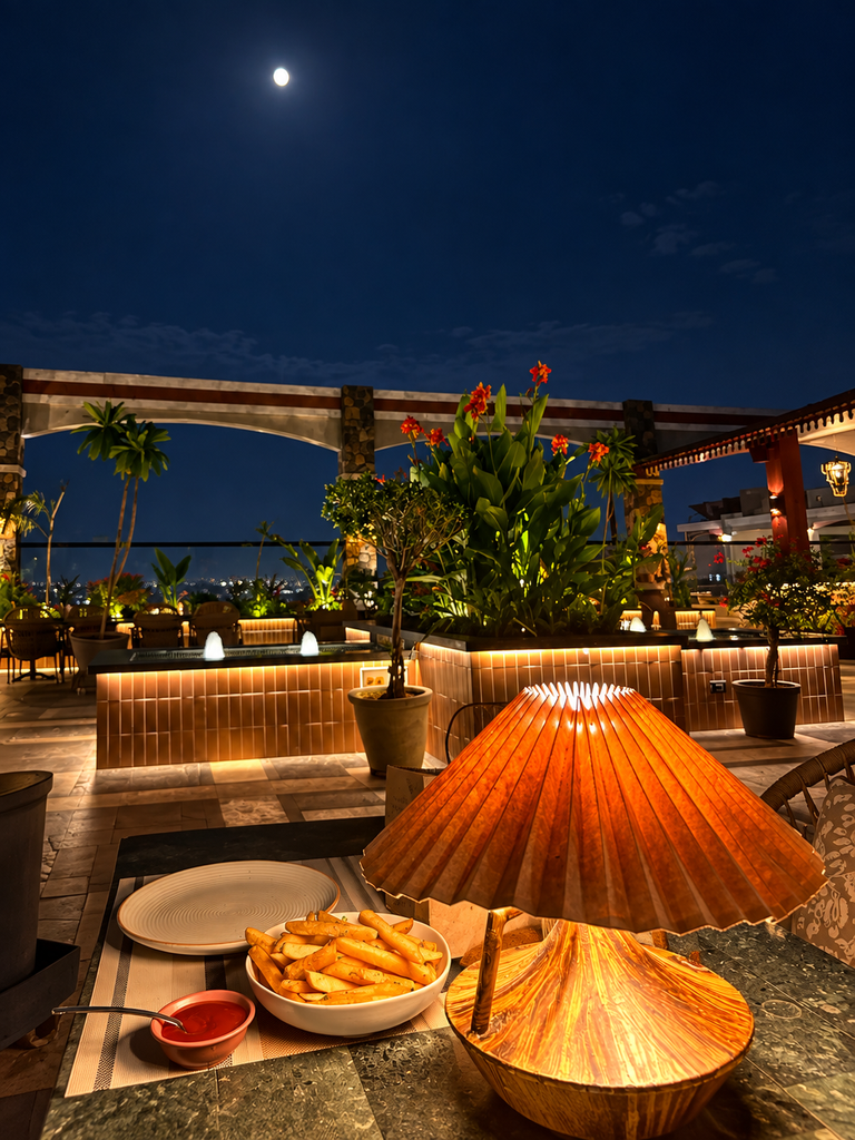 Rooftop restaurants in Panchkula with a cozy night view, warm table lamp, French fries and moonlit ambience at Upstairs